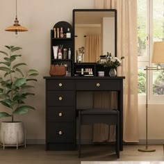 a dressing table with a mirror, stool and potted plant in front of it