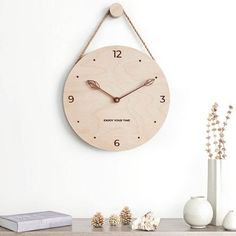 a wooden clock hanging from the side of a wall