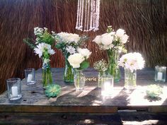 a table topped with vases filled with white flowers