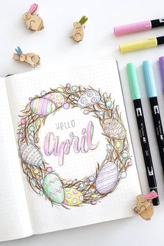 an open notebook with the words hello spring on it and some crayons next to it