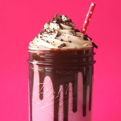 a chocolate milkshake in a glass with a straw sticking out of the top