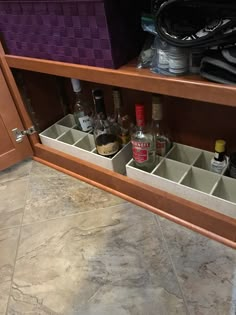 an open cabinet filled with liquor bottles and other items