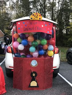 an ice cream truck with balloons in the back