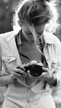 a woman holding a camera in her hands