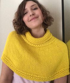 a woman wearing a yellow knitted shawl