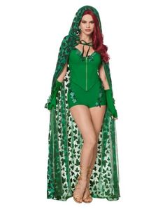 a woman in a green costume with long red hair wearing a veil and matching bodysuit