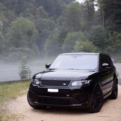 a black range rover parked on the side of a road