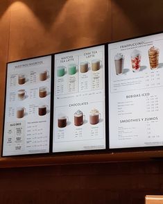 three menus with different drinks on them hanging from the wall in a restaurant or coffee shop