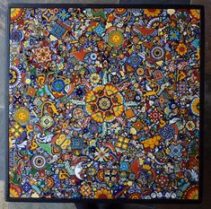 an artistically designed piece of art with many different colors and designs on it's surface