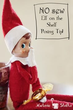 an elf sitting on top of a table next to a jar