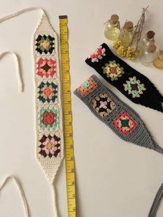 three crocheted headbands next to a measuring tape