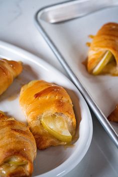 two white plates topped with pastries on top of a table