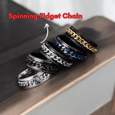 four different types of bracelets sitting on top of a wooden table with the caption spinning flagt chain