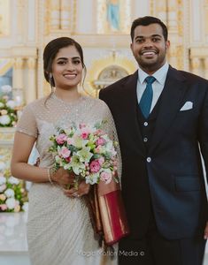 a bride and groom standing in front of the alter at a wedding ceremony, smiling