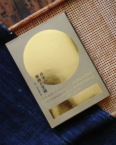 a book sitting on top of a piece of blue cloth next to a bamboo mat