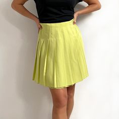 Gorgeous, bright vintage short pleated skirt in juicy lime green. It has wide, sharp pleats all around, stitched down at the waist, and an invisible zip at the back. The skirt is made from a single layer of heavy, yet soft fabric with a nice fall. A smart, youthful skirt for a smart or a casual look. Made by Dorothy Perkins. 50% viscose, 50% polyester. Small size, labelled as 12UK, more of a present day size 8-10UK. Measurements when laid flat are: Waist: 36cm Hips: 54cm Length: 50cm. Excellent, Pleated Green Full Skirt, Casual Green Pleated Full Skirt, Green Pleated Bottoms For Spring, Spring Green Pleated Bottoms, Trendy Green Flared Skirt Bottoms, Retro Pleated Mini Skirt For Spring, Green Skirt With Pleated Hem For Spring, Green Fitted Skirt With Pleated Hem, Fitted Green Skirt With Pleated Hem