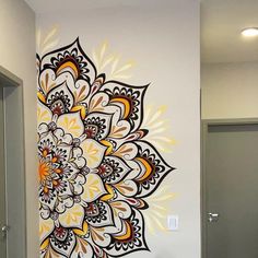 a bathroom with a large flower painted on the wall