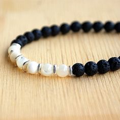 Men's Shell and Lava Stone Beaded BraceletStone: Shell Bead / Lava StoneMetal Type: 925 Sterling SilverGender: For MenStyle: TrendyWidth: 6 mmLength: 6.5 in / 7 in / 7.5 in / 8 in / 8.5 inMinimum Order: 1 Lava Stone Bracelet Men, Mens Lava Bead Bracelet, Lava Rock Bracelet For Men, Adjustable 8mm Lava Stone Beaded Bracelets, Casual Hand-strung Lava Stone Bracelets, Lava Stone, Shell Beads, Sterling Silver Charm, Silver Charms