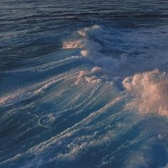 a person riding a surfboard on top of a wave in the middle of the ocean