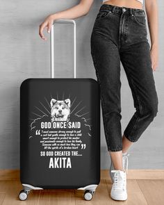 a woman standing next to a suitcase with the words god once said and an akita on it