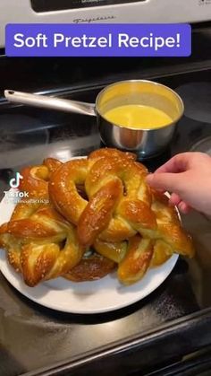 a white plate topped with pretzels next to a bowl of soup