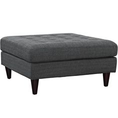 a gray ottoman sitting on top of a wooden table