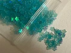 some green and blue glass pieces sitting on the floor