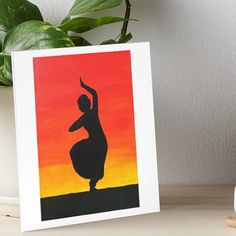 a painting of a woman dancing in the sunset art board print