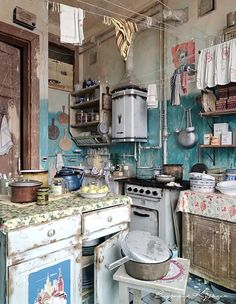 an old - fashioned kitchen with many pots and pans on the stove