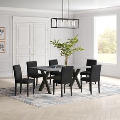 a dining room table with beige chairs and a rug on the floor in front of it