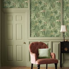 a chair in front of a green wallpapered room