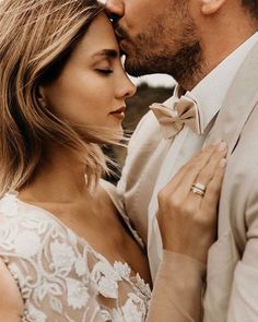 a man and woman standing next to each other with their hands on their chests