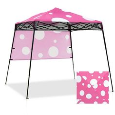 a pink and white tent with polka dots on the side, next to it's cover