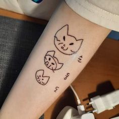 a person with a tattoo on their arm that has cats and kittens drawn on it