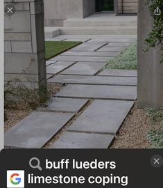 a stone walkway in front of a building with grass growing on the ground and bushes