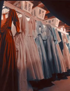 there are many dresses hanging on the rack