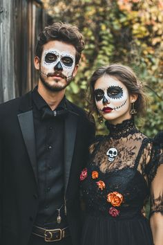 a man and woman in skeleton makeup standing next to each other