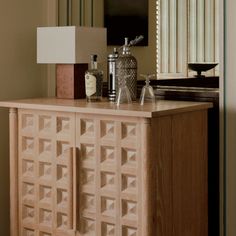 a wooden cabinet sitting in front of a mirror