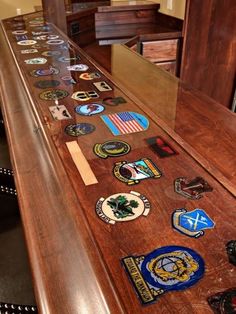 a long wooden counter topped with lots of badges