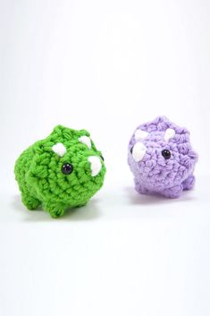 two small crocheted animals sitting next to each other