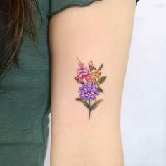 a woman with a flower tattoo on her arm