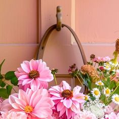 a bunch of pink flowers sitting on top of a table