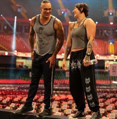 a man and woman standing on top of a stage