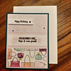 a close up of a greeting card on a table with a wooden surface and a piece of paper that says happy birthday