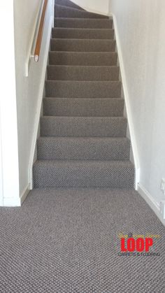 a carpeted staircase leading up to the top floor