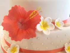 a white cake with orange and yellow flowers on it