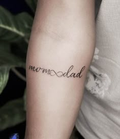 a person with a tattoo on their arm that says, merremad in cursive writing