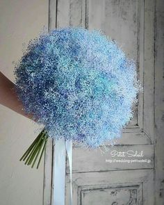 a bouquet of blue flowers in front of a door