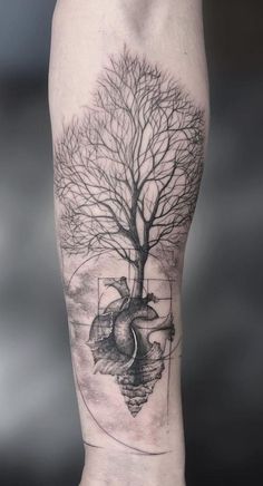 a tree and heart tattoo on the leg