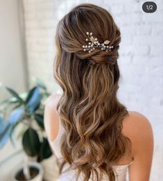 the back of a woman's head wearing a hair comb with flowers in it